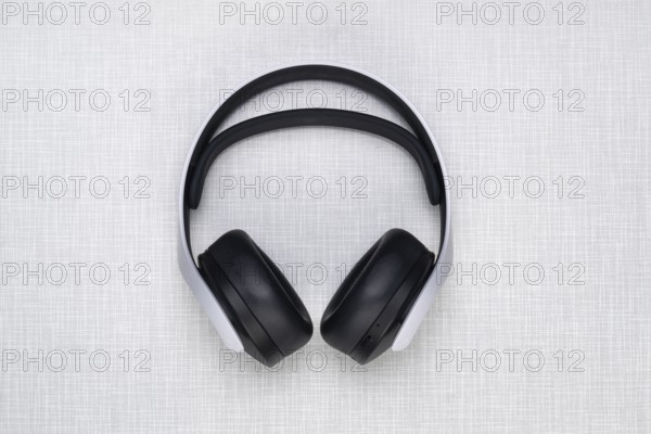 Top shot of a Playstation 5 headphone on a white Resopal plate
