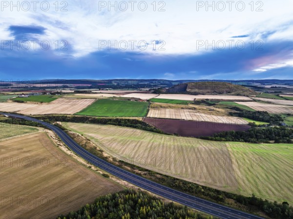 Sunset of Fields and Farms over Traprain Law and Hailes Castle from a drone, River Tyne, Haddington, East Lothian, Scotland, UK