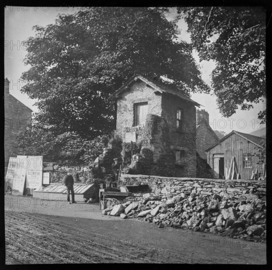 Bridge House in Ambleside, Lake District, Cumbria, England, UK c 1900 offering service repairing umbrellas