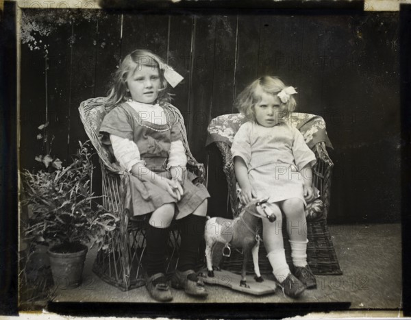 Monochrome magic lantern slide family portrait of two young girls presumably sisters circa 1900