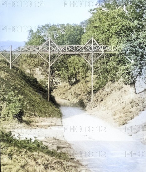 Colourised magic lantern slide of footbridge crossing the road at Wilford Hollows, Bromeswell, Suffolk, England, UK c 1910
