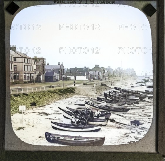 Colorised magic lantern slide by Poulton of boats on the beach in front of Esplanade buildings around the Royal Hotel, Redcar, Teeside, North Yorkshire, England, UK c 1900