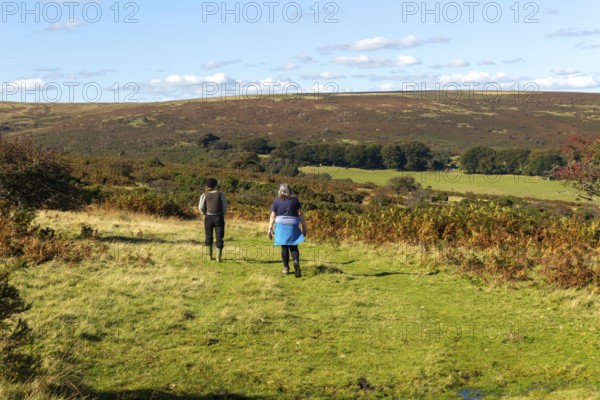 Two women, mother and daughter, walking on moorland in autumn, near Hayford, Buckfastleigh, Dartmoor national park, Devon, England, UK