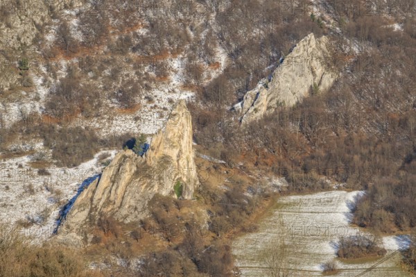 Cervenokamenské cliff (cervenokamenske bradlo), a huge rock at a mountain with bushes, trees and meadows in winter, Vápec, Horná Poruba, Slovakia