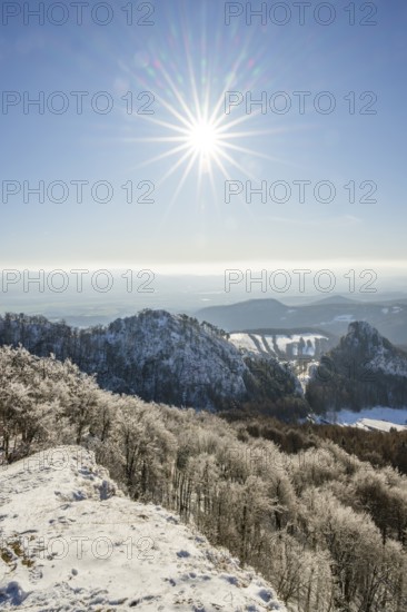 View over the hills and valleys from the mountain with hoarfrost on the branches in winter, Vápec, Horná Poruba, Slovakia