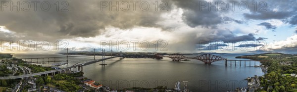 Sunset Panorama of Rain clouds over Forth Bridge from a drone, Queensferry Crossing, Forth Estuary, Scotland, United Kingdom