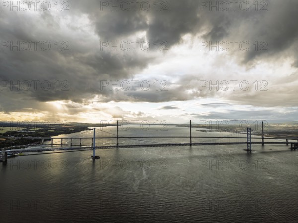 Rain clouds over Forth Road Bridge and The Queensferry Crossing from a drone, Queensferry Crossing, Forth Estuary, Scotland, United Kingdom