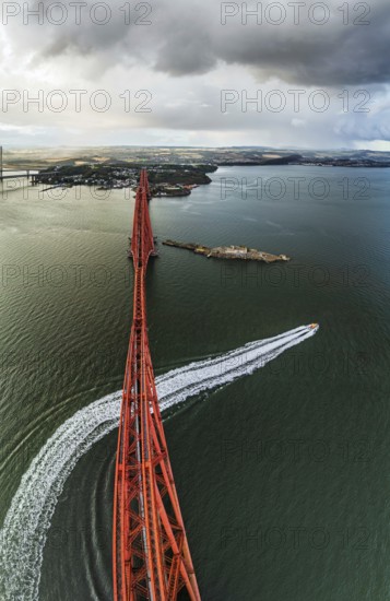 Horizontal panorama of Rain clouds over Forth Bridge from a drone, Queensferry Crossing, Forth Estuary, Scotland, United Kingdom