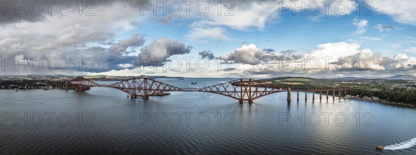 Panorama of Rain clouds over Forth Bridge from a drone, Queensferry Crossing, Forth Estuary, Scotland, United Kingdom
