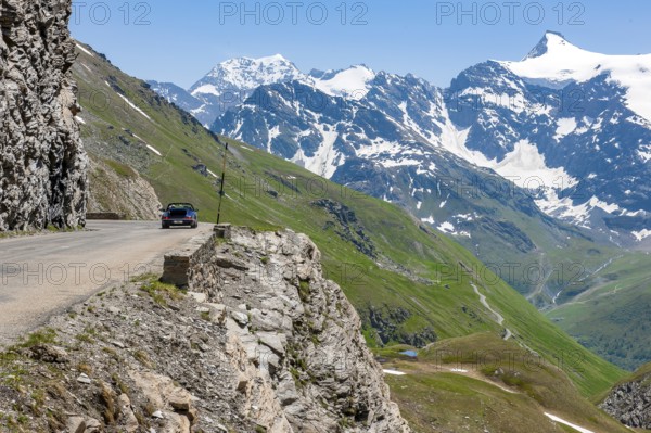 View of alpine road carved into rocky escarpment in high Alps near pass summit of highest asphalted passable 2764 2770 metres high alpine pass Col de l'Iseran Iseranpass, Iseran, Col de l' Iseran, departmental road D902, Route des Grandes Alpes, Département Savoie, Region Auvergne-Rhône-Alpes, Graian Alps, France