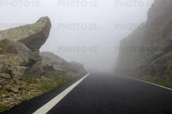 Fog on pass road Alpine pass Colle del Col de Nivolet, Gran Paradiso National Park, Ceresole Reale, Piedmont, Italy