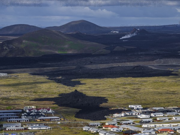 Lava, lava field, village, houses, summer, cloudy, sunny, aerial view, volcanic eruption, July 2025, Grindavik, Sundhnúkur crater series, Fagradalsfjall, Reykjanes, Iceland