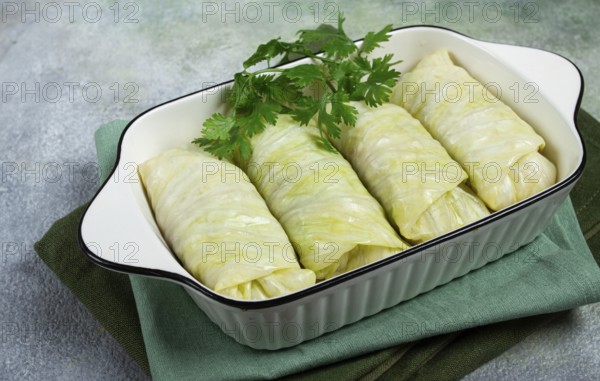 Raw cabbage rolls, not cooked, with minced meat, top view, without people, in the spotlight