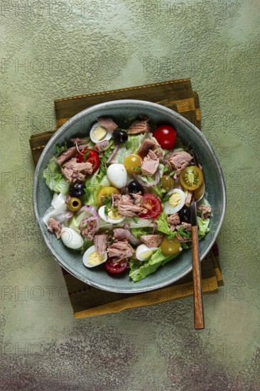 Salad with canned tuna, vegetable salad with quail eggs, lettuce, red onion, cherry tomatoes, olives, keto food, healthy food, homemade, no people