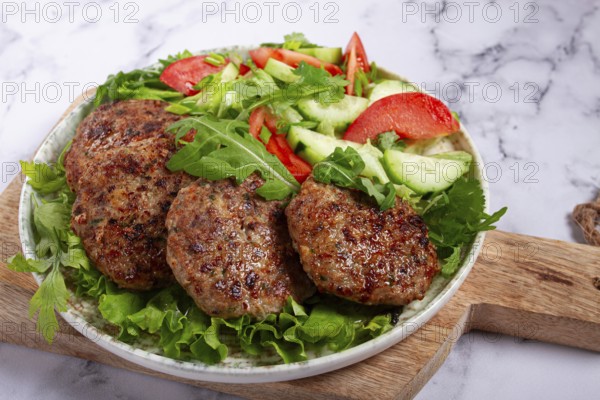 Fried cutlets, mixed minced meat, with vegetable salad, homemade, top view, no people