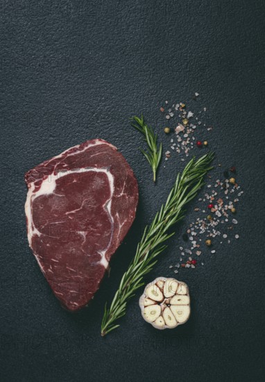 Raw steak, beef steak, rib eye steak, on the table, top view, no people, on a dark background