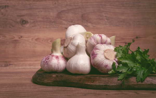 Fresh young garlic, white and purple color, on a wooden table, no people