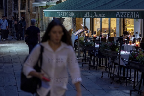 Venice, Italy - 2 September 2025: People stroll in San Marco in Venice at sunset during the 82nd Venice International Film Festival
