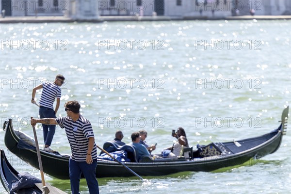 Venice, Italy - 3 September 2025: Gondolier on a gondola in Venice during the 82nd Venice International Film Festival