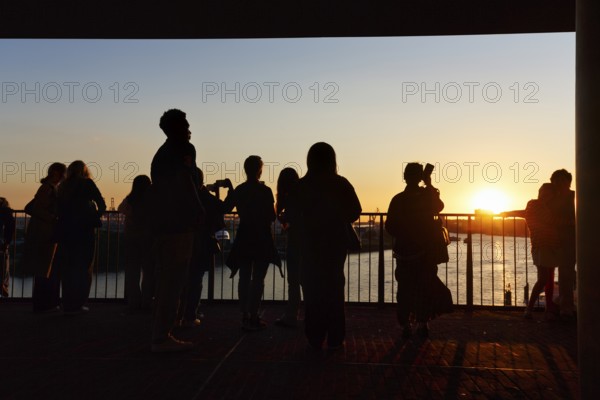 Crowd enjoying the view from the Elbphilharmonie over the Elbe at sunset, silhouettes, Plaza viewing platform, Hamburg, Germany