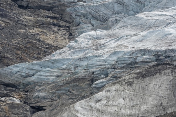 Majestic ice formations dominate the rocky terrain and show the beauty of a glacier in a secluded mountain location in daylight. The inseparable textures emphasise the artistry of nature. Gorner Glacier, Zermatt, Valais, Alps, Swiss