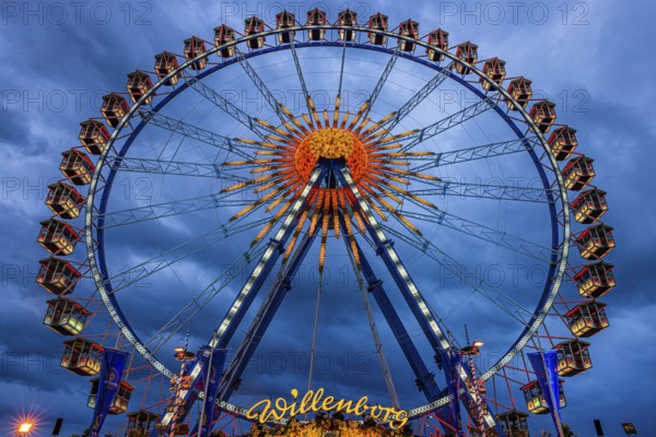 Dark clouds behind the illuminated Ferris wheel, Festwiese, Theresienwiese, Oktoberfest, Munich, Upper Bavaria, Bavaria, Germany