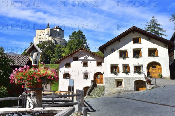 Village fountain in Tarasp, municipality of Scuol, in the background Tarasp Castle in the Lower Engadine, Grisons, Switzerland