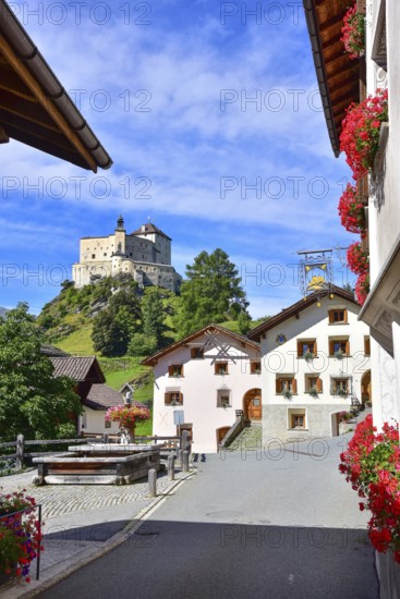 Village fountain in Tarasp, municipality of Scuol, in the background Tarasp Castle in the Lower Engadine, Grisons, Switzerland