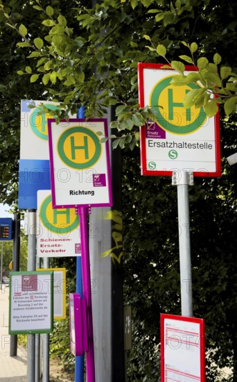 Many signs for rail replacement services due to construction work on Deutsche Bahn railway lines in Wuppertal, Germany, digitally reworked