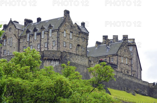 Old castle surrounded by green nature with overcast sky, Edinburgh Castle, Old Town, Edinburgh, Scotland, United Kingdom