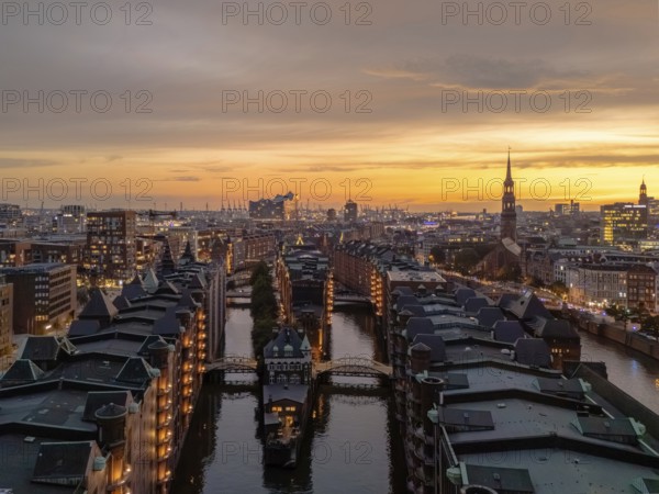 Aerial view of the Speicherstadt Hamburg with evening lighting and view over the harbour with Elbphilharmonie, Hamburg, Germany