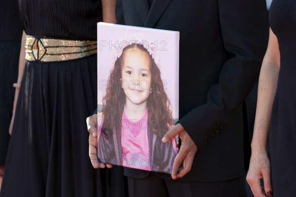 Venice, Italy - 3 September 2025: Motaz Malhees with a portrait of five-year-old Palestinian girl Hind Rajab, who was killed by the Israeli army in the Gaza Strip in January 2024, during the red carpet of - The Voice Of Hind Rajab - during the 82nd Venice International Film Festival