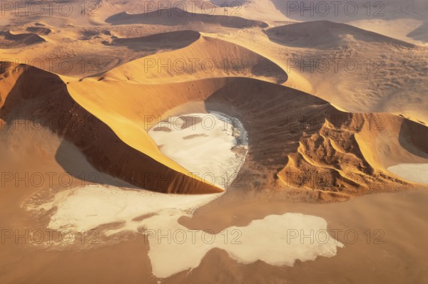 Sand dunes and dry pans in the Namib Desert. In the evening. Aerial view. Namib-Naukluft Park, Namibia