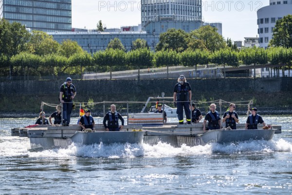 Exercise run of a multi-purpose pontoon on the Rhine, Medienhafen, of the Water Hazards Section, in Düsseldorf, the motorised pontoon can be used as a ferry for people or equipment, as a working platform or bridge, during the major exercise FÜLEX25, lasting several days, of the THW, Technisches Hilfswerk, Landesverband North Rhine-Westphalia, on 4 weekends over 3500 volunteers from the 127 North Rhine-Westphalia local associations practise many different deployment scenarios