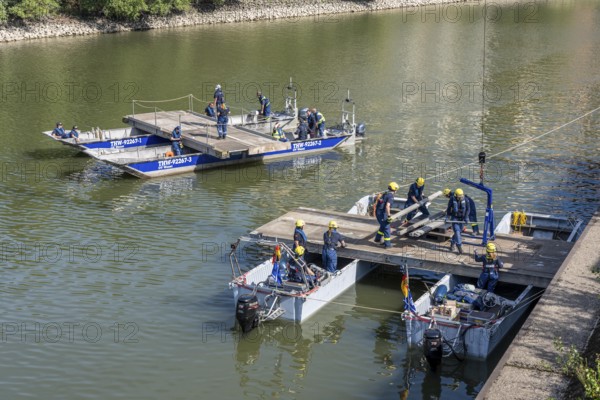 Construction of a multi-purpose pontoon, the specialist group for water hazards, in Düsseldorf, the motorised pontoon can be used as a ferry for people or equipment, as a working platform or bridge, during the major exercise FÜLEX25, lasting several days, of the THW, Technisches Hilfswerk, Landesverband North Rhine-Westphalia, over 3500 volunteers from the 127 North Rhine-Westphalia local associations practise many different deployment scenarios over 4 weekends