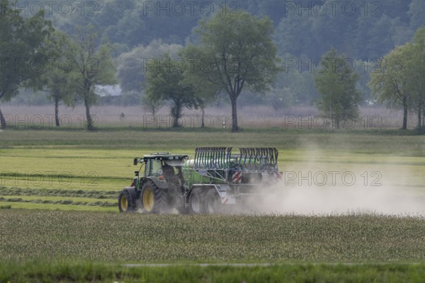 Tractor driving with slurry tanker, meadow, dust, drought, summer, Alpine foothills, Bad-Tölz district, Bavaria, Germany