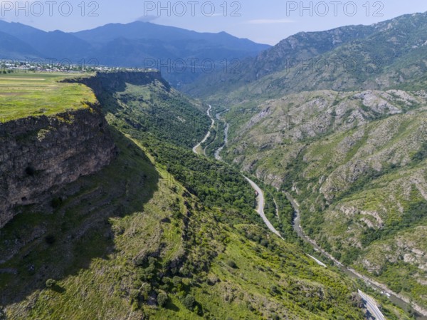 View of a picturesque valley with a river, surrounded by high mountains and lush vegetation under a blue sky, aerial view, landscape near Odsun, Odzun, Debed Gorge, Lorikeet Province, Armenia