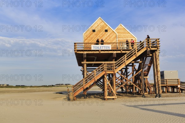 Pile dwelling, toilet house on the beach, walker, Sankt Peter-Ording, Eiderstedt peninsula, Wadden Sea National Park, North Sea, North Frisia, Schleswig-Holstein, Germany