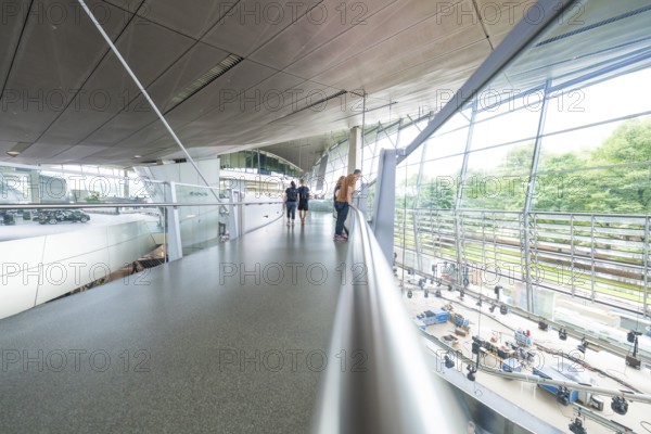 Glass balcony in a modern space with people enjoying the view, BMW Welt, Munich, Germany