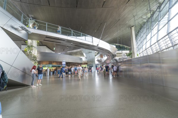 Futuristic interior with lots of people and modern architecture, BMW Welt, Munich, Germany
