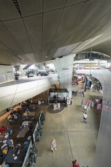View from above of a modern interior with restaurant and people, BMW Welt, Munich, Germany