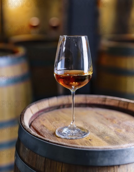 Glass of 10-year-old tawny wine placed on a barrel in a vineyard restaurant, AI generated