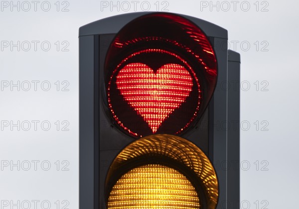 Traffic light with red light in the shape of a heart, Akureyri, North Iceland, Iceland