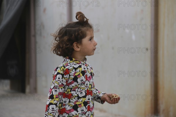 A Syrian refugee child photographed in a camp, reflecting the harsh living conditions of displaced families. Aleppo, Syria March 2, 2017, Aleppo, Syria