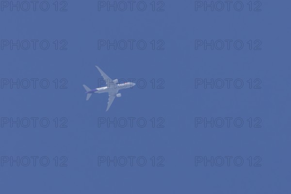 Airbus A300-600RF jet aircraft of FedEx Express airlines in flight in a blue sky, England, United Kingdom