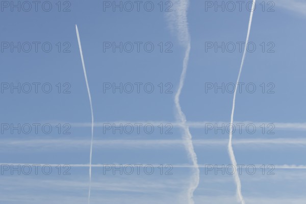 Jet aircraft vapour trails or contrails in a blue sky, England, United Kingdom