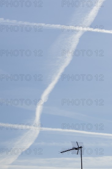 Jet aircraft vapour trails or contrails in a blue sky, England, United Kingdom