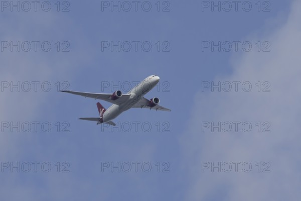 Boeing 787 Dreamliner jet passenger aircraft of Virgin Atlantic airlines in flight in a blue sky, England, United Kingdom