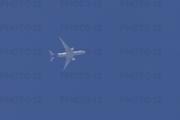 Airbus A300-600RF jet aircraft of FedEx Express airlines in flight in a blue sky, England, United Kingdom