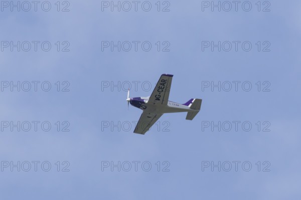 Alpi Pioneer 300 light aircraft flying in a blue sky, England, United Kingdom